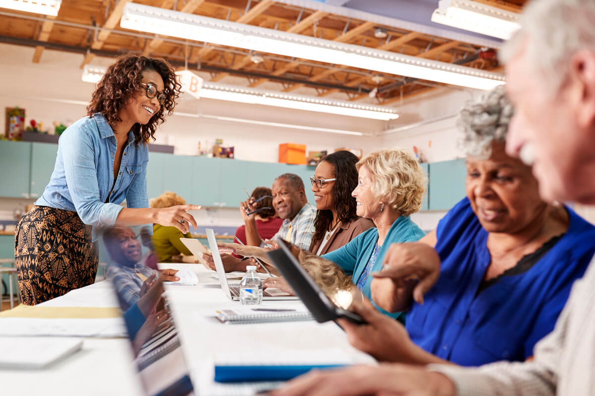 Group of seniors at a table with tablets