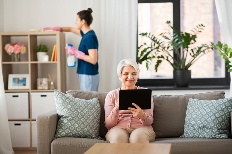 Senior sitting on a couch with a tablet