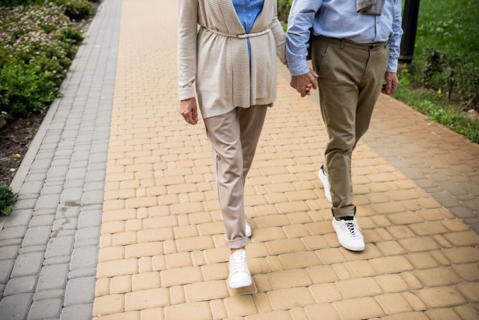 Partial view of senior couple walking across