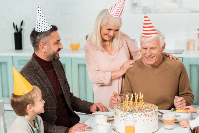 Senior woman touching shoulders of happy man