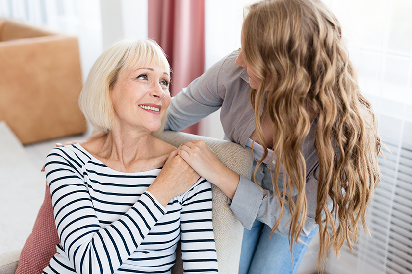 Loving mother looking at her daughter at home 